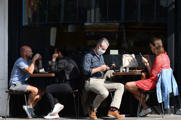 Members of the public sit outside as they enjoy the weather in southwest London. 