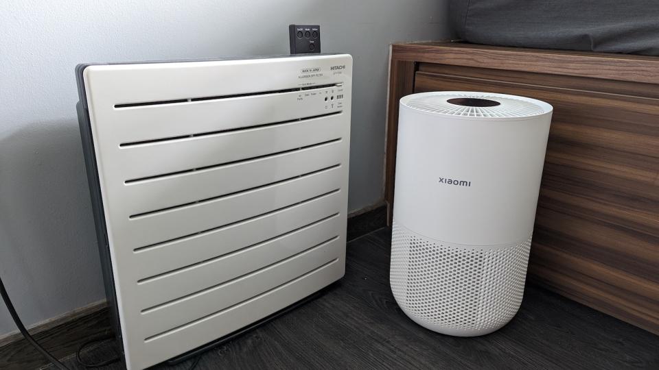 The Hitachi EP-PZ30J and Xiaomi Smart Air Purifier 4 Compact side by side on the floor.