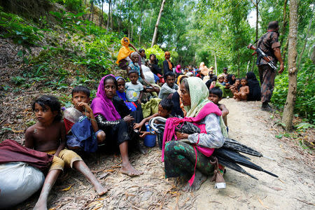 Rohingya people sits on the Bangladesh side as they are restricted by the members of Border Guards Bangladesh (BGB), to go further inside Bangladesh, in Cox’s Bazar, Bangladesh August 28, 2017. REUTERS/Mohammad Ponir Hossain