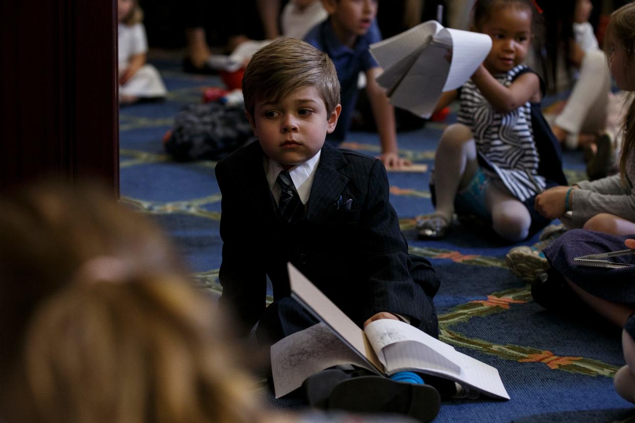 A child listens to House Minority Leader Nancy Pelosi (D-CA) speak with journalists' kids during her weekly press conference on 'Take our Daughters and Sons to Work Day' at the Capitol on April 26, 2018 in Washington, D.C.