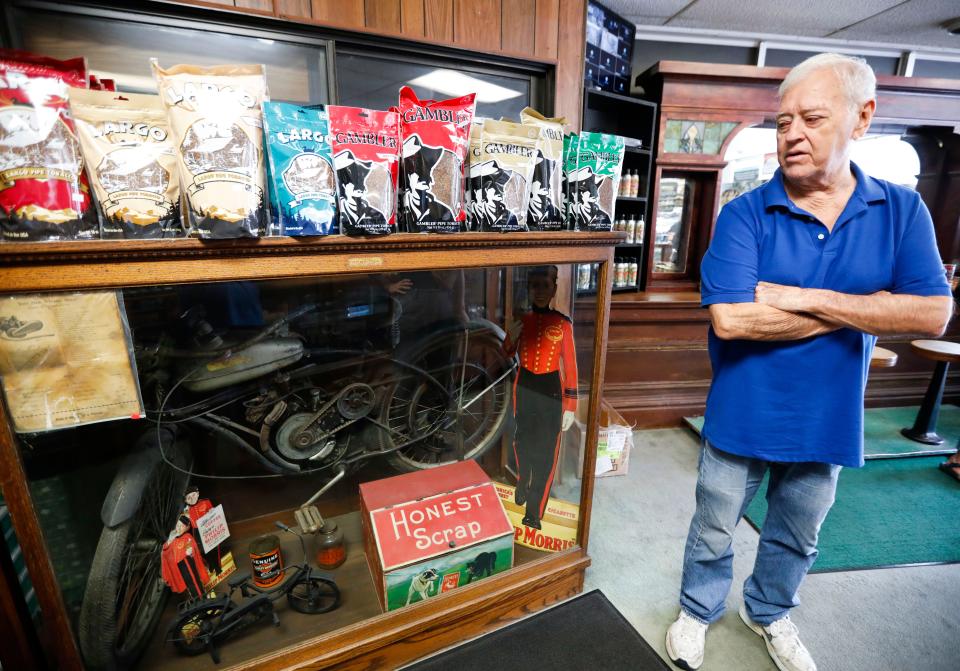 Don Johnson, owner of Don Johnson's Tobacco World on Glenstone Avenue for over 30 years, won't be putting this Whizzer motorbike up for auction when over 200 items in his collection go up for auction later this month.