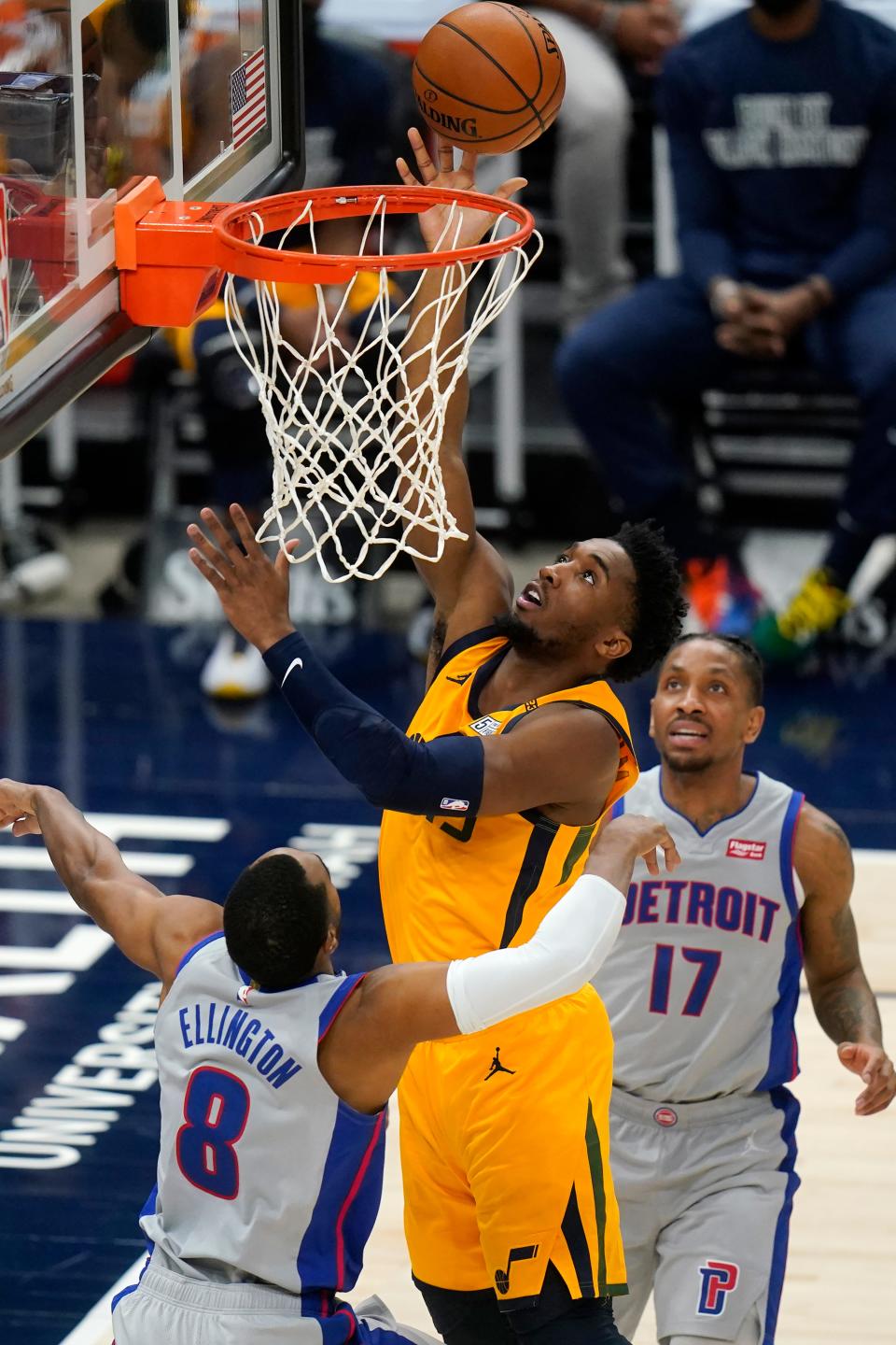 Jazz guard Donovan Mitchell, center, lays the ball as the Pistons' Wayne Ellington, left, and Rodney McGruder defend during the first half on Tuesday, Feb. 2, 2021, in Salt Lake City.