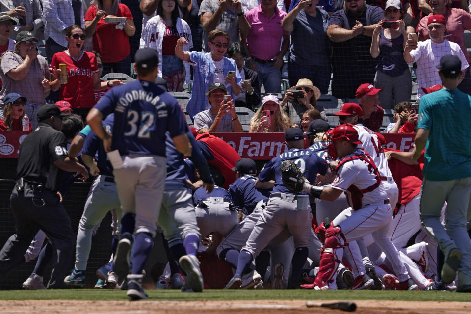 Several members of the Seattle Mariners and the Los Angeles Angels scuffle after Mariners' Jesse Winker was hit by a pitch during the second inning of a baseball game Sunday, June 26, 2022, in Anaheim, Calif. (AP Photo/Mark J. Terrill)