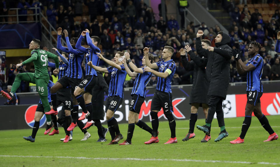 FILE - In this Wednesday, Feb. 19, 2020 file photo, Atalanta players celebrate at the end of the Champions League round of 16, first leg, soccer match between Atalanta and Valencia at the San Siro stadium in Milan, Italy. It was the biggest soccer game in Atalanta’s history and a third of Bergamo’s population made the short trip to Milan’s famed San Siro Stadium to witness it. Nearly 2,500 fans of visiting Spanish club Valencia also traveled to the Champions League match. More than a month later, experts are pointing to the Feb. 19 game as one of the biggest reasons why Bergamo has become one of the epicenters of the coronavirus pandemic — a “biological bomb” was the way one respiratory specialist put it — and why 35% of Valencia’s team became infected. The new coronavirus causes mild or moderate symptoms for most people, but for some, especially older adults and people with existing health problems, it can cause more severe illness or death. (AP Photo/Luca Bruno, File)