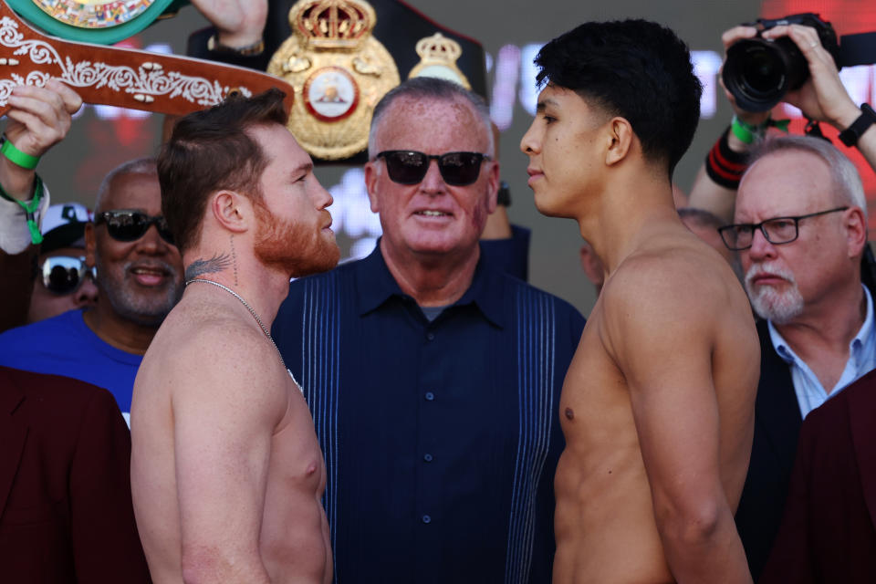 LAS VEGAS, NEVADA - MAY 03: Canelo Álvarez of Mexico (L) and Jaime Munguia of Mexico (R) face off during a ceremonial weigh-in ahead of their super middleweight fight at T-Mobile Arena on May 03, 2024 in Las Vegas, Nevada. (Photo by Cris Esqueda/Golden Boy/Getty Images)