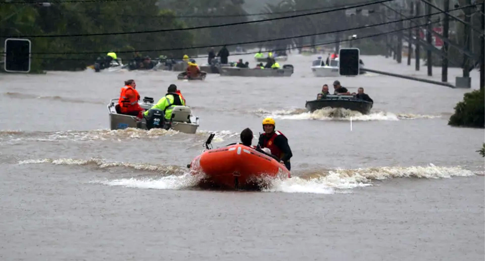 Rescuers on boats during Lismore's floods. 