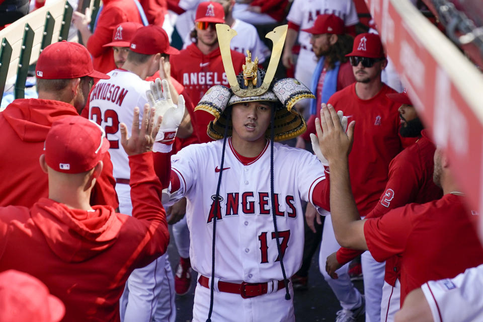 FILE - Los Angeles Angels designated hitter Shohei Ohtani (17) celebrates in the dugout after hitting a home run during the ninth inning of a baseball game against the Houston Astros in Anaheim, Calif., Wednesday, May 10, 2023. Mike Trout also scored. Shohei Ohtani has been named The Associated Press' Male Athlete of the Year for the second time in three years. (AP Photo/Ashley Landis, File)