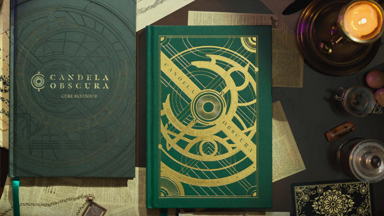  Two copies of the Candela Obscura rulebook on a desk strewn with esoteric items  and a candle. 