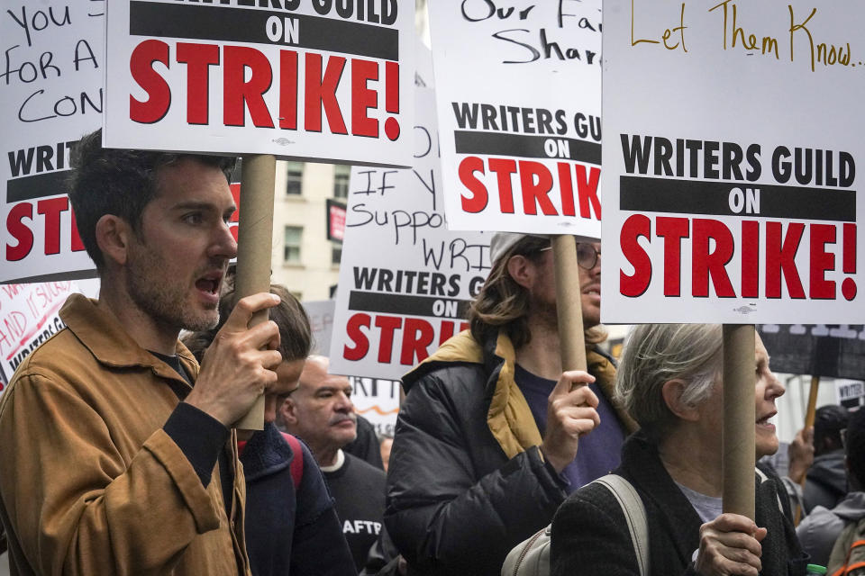 Striking writers hold signs as they march and picket calling for better wages, Tuesday, May 2, 2023, outside Peacock NewFront in New York. (Bebeto Matthews / AP)