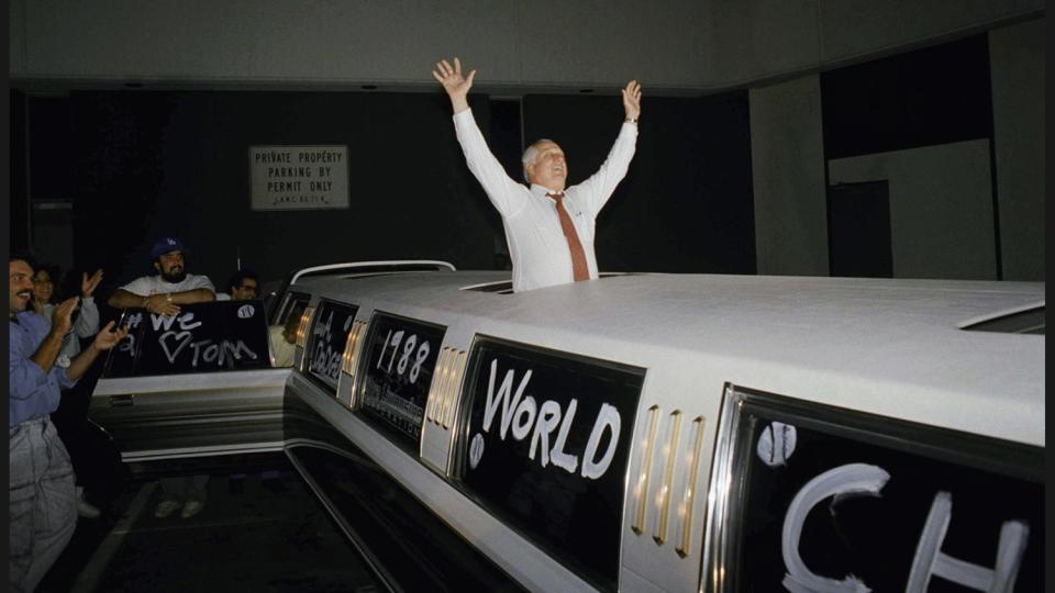 Tommy Lasorda celebrates the Dodgers' 1988 World Series victory from a stretch limousine in Los Angeles.