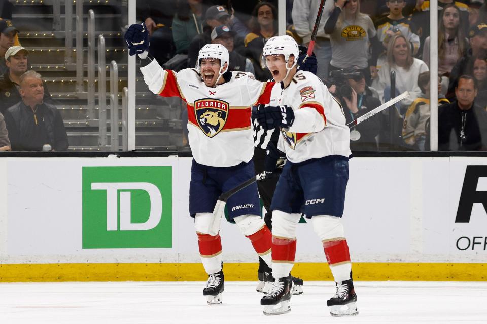 Florida Panthers forward Evan Rodrigues (left) celebrates his first-period goal against the Boston Bruins with Anton Lundell (15).