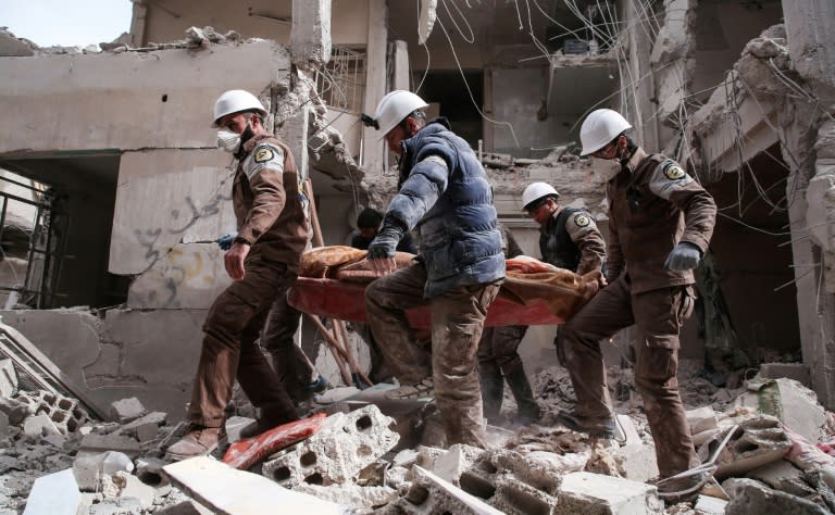 Syrian civil defence volunteers, known as the White Helmets, search for survivors following reported government airstrike on the rebel-held neighbourhood of Tishrin, on the northeastern outskirts of the capital Damascus, on February 22, 2017