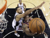 Portland Trail Blazers' Wesley Matthews, right, shoots around San Antonio Spurs' Tim Duncan, left, during the first half of Game 1 of a Western Conference semifinal NBA basketball playoff series, Tuesday, May 6, 2014, in San Antonio. (AP Photo/Eric Gay)