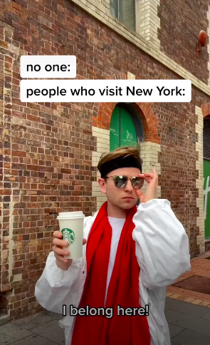 Pavel wearing sunglasses and holding a Starbucks cup wit the caption "I belong here!"