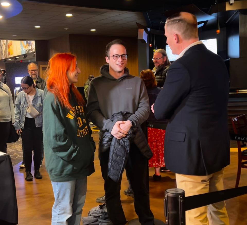 Wayne State student Abby Barnett, 24, of Farmington and Jake Rubin, 24, pose for a photo with Marc Evan Jackson ahead of a "Mean Girls" charity screening on Saturday, March 30, 2024, at Emagine Theater in Royal Oak.