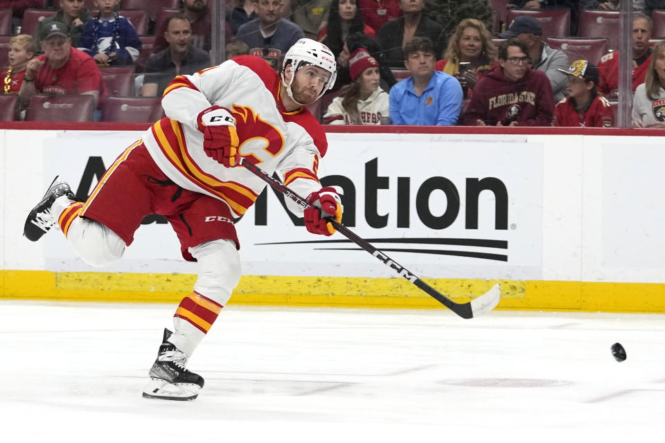 Calgary Flames center Kevin Rooney takes a shot on goal during the first period of an NHL hockey game against the Florida Panthers, Saturday, March 9, 2024, in Sunrise, Fla. (AP Photo/Lynne Sladky)