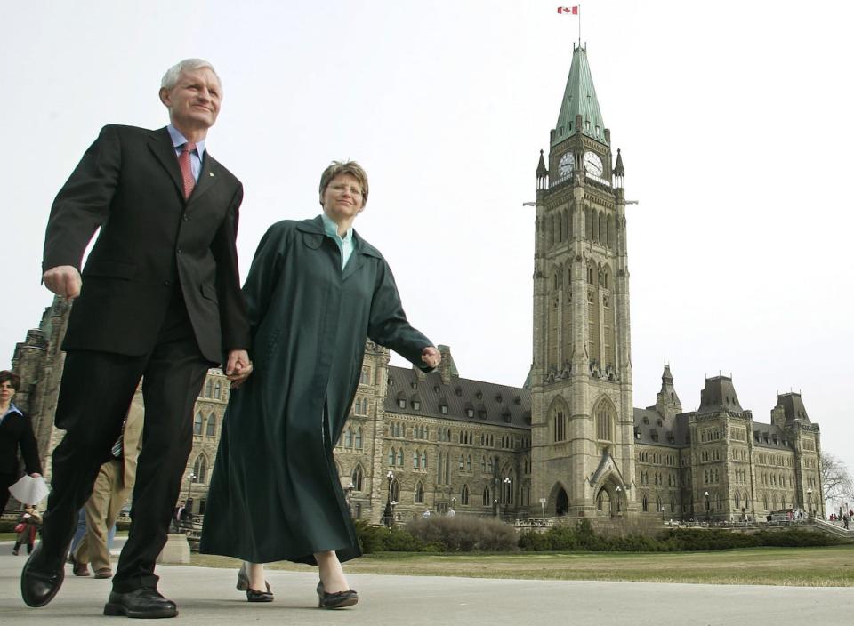 Liberal MP John Godfrey leaves Parliament Hill with his wife Patricia Bongard after announcing, for health reasons, he is withdrawing from the Liberal leadership race, in Ottawa Wednesday April12, 2006.