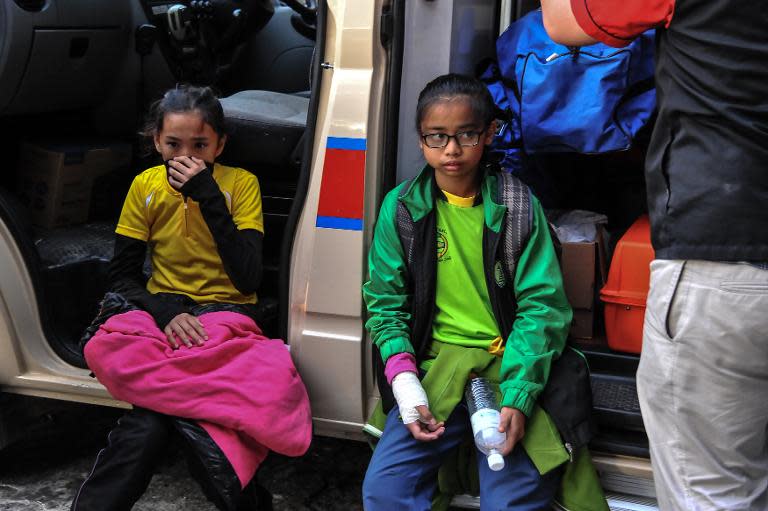 Young injured Singaporean students resting after an earthquake in Kundasang, a town in the district of Ranau
