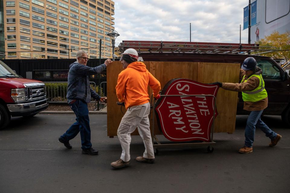 Kevin Andrews, 62, of Macomb Township, a maintenance supervisor for The Salvation Army Great Lakes Division, helps roll a wooden platform and a large red sign from The Salvation Army at Cadillac Square in Detroit on Friday, Nov. 10, 2023.