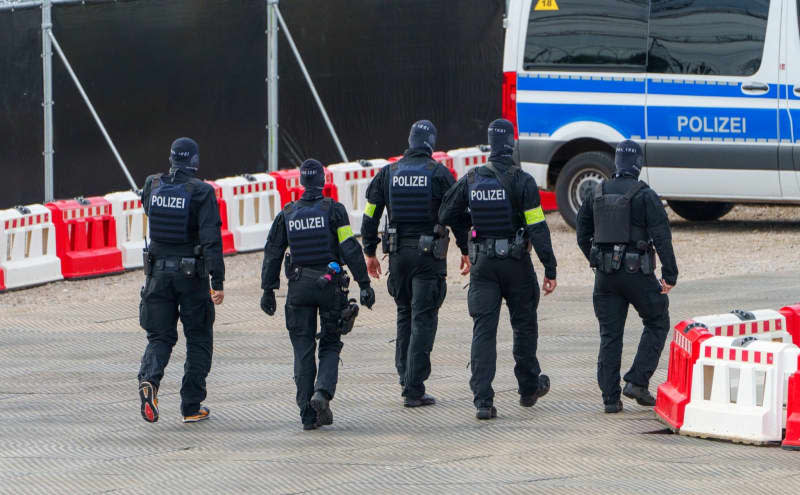 Police officers walk in front of the Frankfurt Higher Regional Court ahead of the second and highest-profile trial linked to a far-right coup plot in Germany, with the alleged 72-year-old ringleader, Prince Heinrich XIII of Reuss, going before the court. Andreas Arnold/dpa
