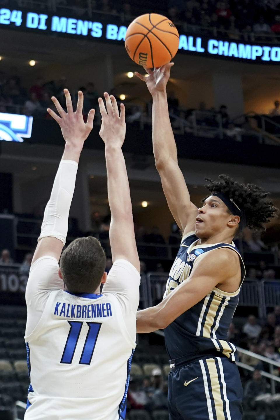 Akron's Enrique Freeman shoots over Creighton's Ryan Kalkbrenner during the first half of a college basketball game in the first round of the NCAA men's tournament Thursday, March 21, 2024, in Pittsburgh. (AP Photo/Matt Freed)