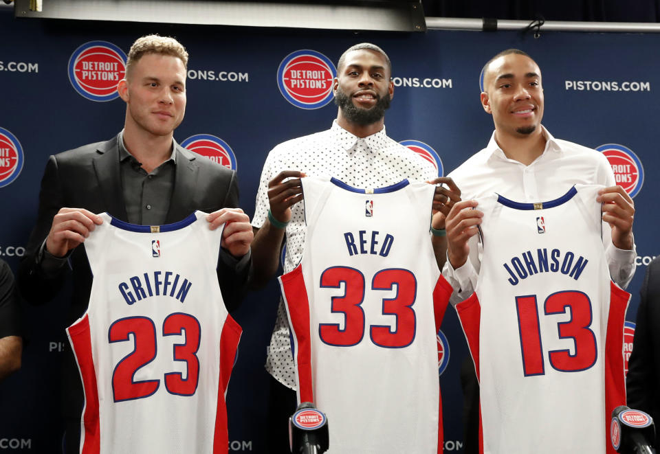 Blake Griffin, from left, Willie Reed and Brice Johnson pose with their new Detroit Pistons uniforms. (AP)