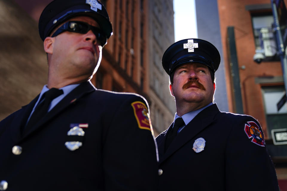 Firefighters from Massachusetts gather with others outside the National September 11 Memorial and Museum during a ceremony marking the 20th anniversary of the 9/11 terrorist attacks, Saturday, Sept. 11, 2021, in New York. (AP Photo/Matt Rourke)