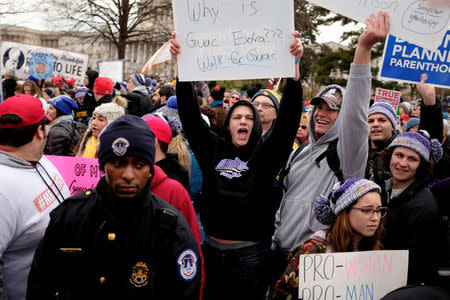 A counter-protester holds a sign as the annual March for Life concludes at the U.S. Supreme Court in Washington,DC, U.S. January 27, 2017. REUTERS/James Lawler Duggan