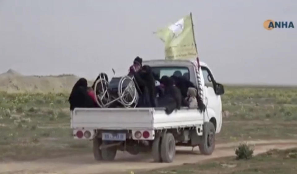 In this Sunday, Feb. 10, 2019 image from video provided by Hawar News Agency, ANHA, an online Kurdish news service, civilians flee fighting near Baghouz, Syria. Fierce fighting was underway Monday between U.S.-backed Syrian forces and the Islamic State group around the extremists' last foothold in eastern Syria. The capture of the IS-held village of Baghouz and nearby areas would mark the end of a four-year global war to end IS' territorial hold over large parts of Syria and Iraq, where the group established its self-proclaimed "caliphate" in 2014. (ANHA via AP)