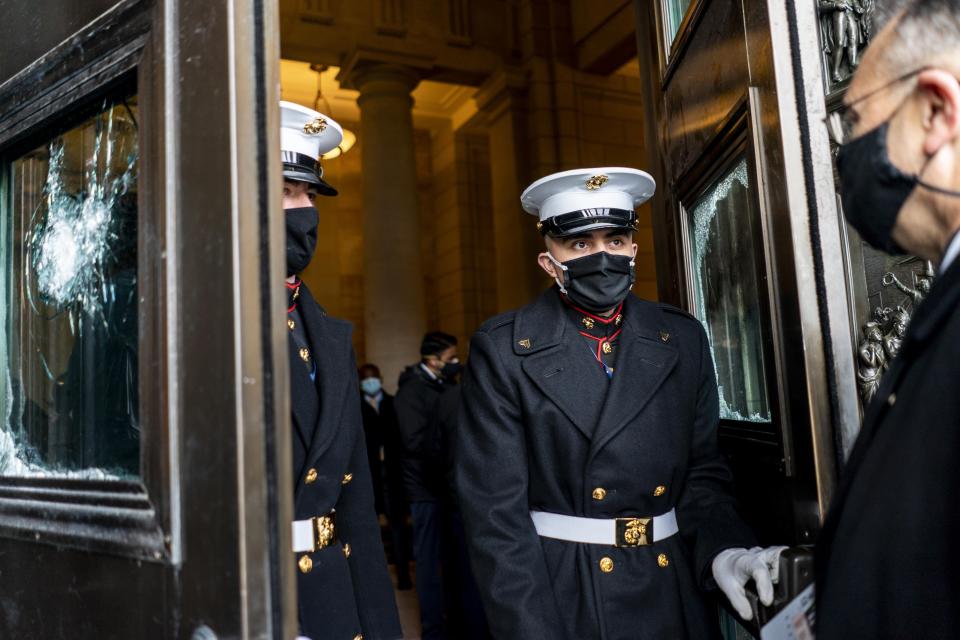 U.S. Marine Corps. stand in the doorway between damaged Capitol doors during a rehearsal for the 59th inaugural ceremony for President-elect Joe Biden and Vice President-elect Kamala Harris on Monday, Jan. 18, 2021 at the U.S. Capitol in Washington. (Melina Mara/The Washington Post via AP, Pool)