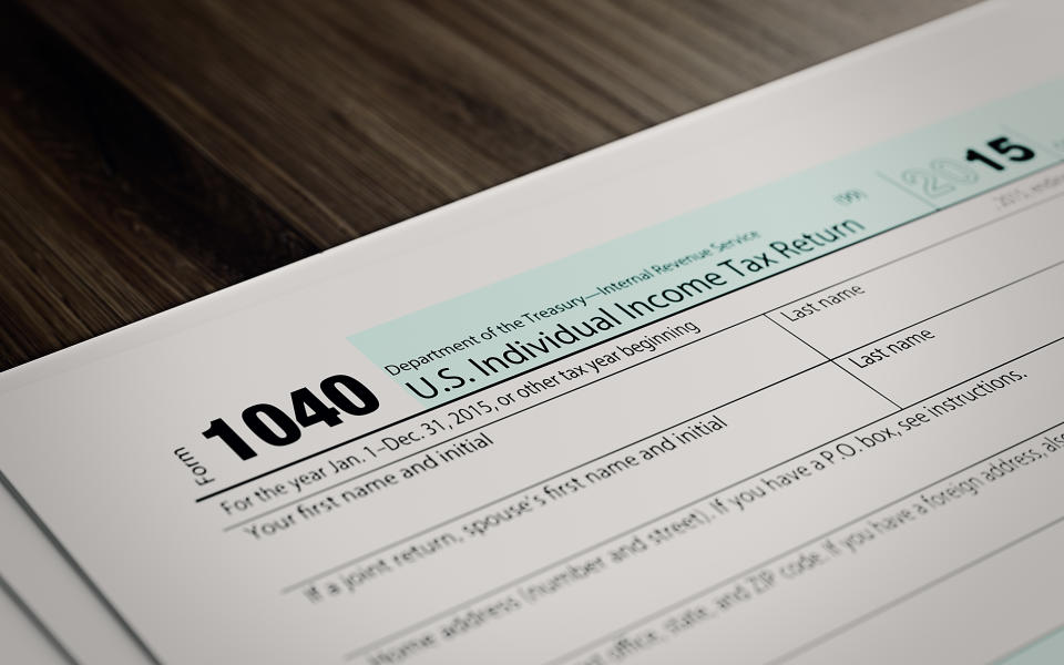 Tax refund form on brown wood surface. Horizontal composition with copy space and selective focus.