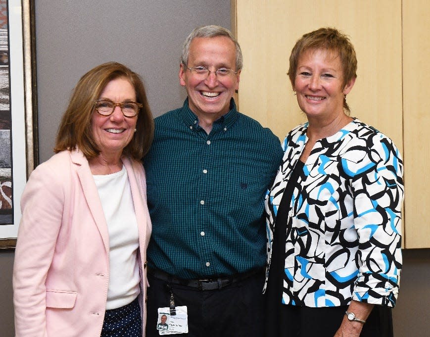 Charles Cappetta, MD, Dartmouth Health Children’s pediatrician and children’s health advocate (center), has been selected as the recipient of the 2022 Sandi Van Scoyoc Legacy Award by the New Hampshire Children’s Health Foundation. Cappetta was honored in a ceremony at Dartmouth Health’s regional administrative office in Bedford on Monday, June 6, where Gail Garceau, president of the New Hampshire Children’s Health Foundation (right), presented him with the award and a $2,500 check, which he donated to Court Appointed Special Advocates for Children New Hampshire. CASA NH president and CEO Marty Sink (left) was on-hand to accept the donation.