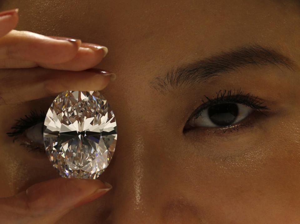 This 118.28 carat, D colour, flawless, type IIA magnificent oval diamond, which was referred to at the time as "the greatest white diamond ever to appear at auction," sold for $238.7 million in Hong Kong dollars (approximately $30.6M USD) at a Sotheby's auction in Hong Kong in October 2013. (REUTERS/Bobby Yip)