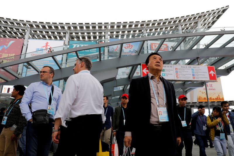 FILE PHOTO: Visitors attend the China Import and Export Fair, also known as Canton Fair, in the southern city of Guangzhou