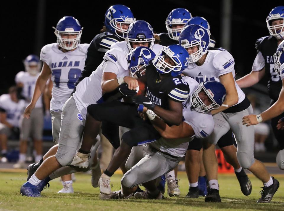 Eastern's Quintel Thomas (26) is swarmed by a host of Oldham County defenders during their game at the Eastern High School in Louisville, Ky. on Sep. 30, 2021.