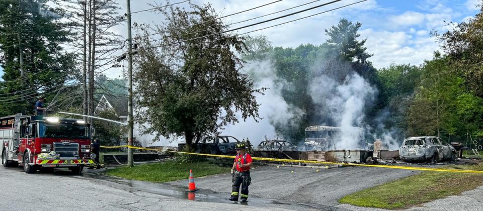 Auburn firefighters hose down the remains of a home in Auburn, Maine, early Saturday. The home went up in flames during a standoff with police (AP)