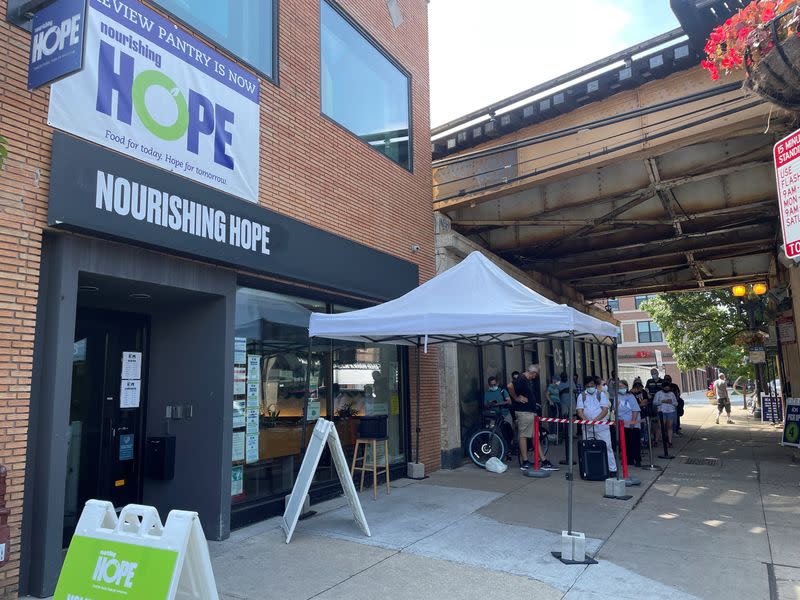 People wait in line for free groceries at nourishing hope food pantry in Chicago