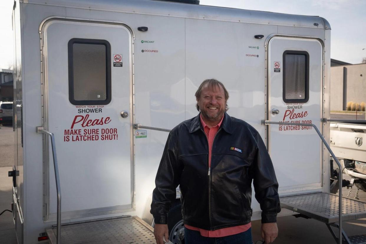 Showered With Hope founder Ted Hayward stands in front of the mobile shower unit the organization will operate in Rapid City.