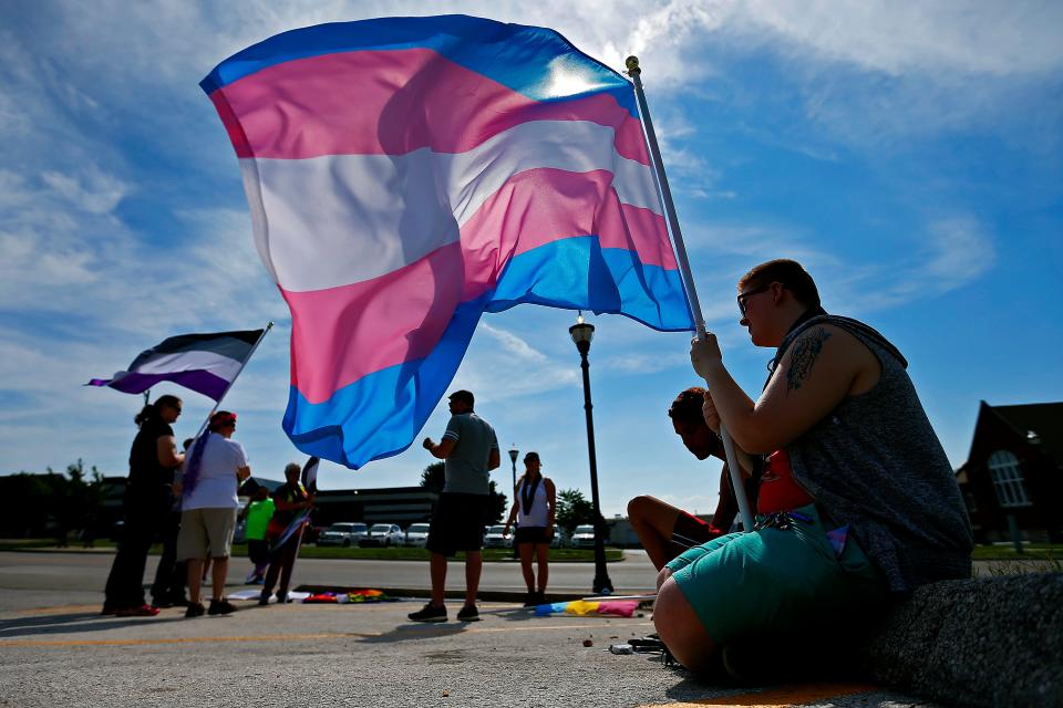 Flag bearer Scott Young holds the transgender Pride flag prior to the start of the Equality March as part of the 2016 Greater Ozarks Pridefest in Springfield, Mo. on June 17, 2016. The flags represent different gender identities and sexual orientations within the greater LGBTQ Pride movement.