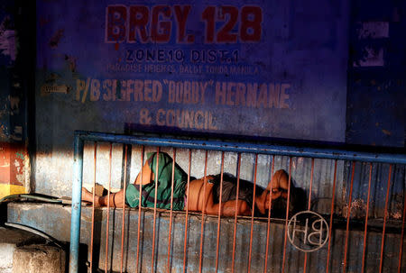 A man sleeps on a roadside in Tondo, Manila, Philippines July 3, 2018. REUTERS/Erik De Castro/Files