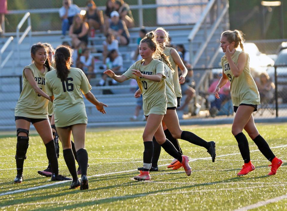 Penn girls soccer players celebrate after freshman Maddy Johnson, center, scored a goal late in the first half of a victory over Concord Tuesday, Aug. 22, 2023 at Penn High School.