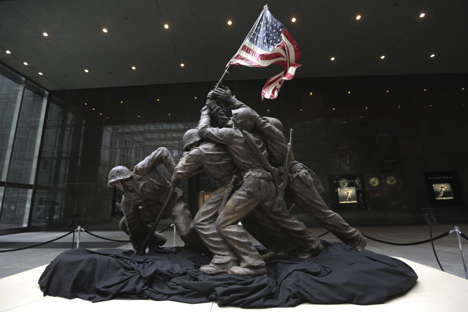 <p>For four decades, the original cast stone version of the Marine Corps Memorial statute of troops raising the American flag over Iwo Jima was hidden under a tarp in the backyard of its sculptor, Felix de Weldon. In 1990, World War II buff Rodney Brown discovered the statute and procured it from de Weldon, and in 2013 it was sold at auction. (AP Photo/Mary Altaffer) <a href="http://www.huffingtonpost.com/2013/02/20/iwo-jima-statue-for-sale-rodney-brown-wwii-memorabilia_n_2725858.html" target="_blank">Read more here.</a></p> <p>&nbsp;</p> <p><em>CORRECTION: An earlier version of this slide erroneously described the troops in the statue as soldiers.&nbsp;</em></p>