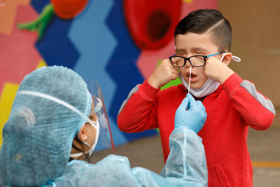 April 13, 2021: Kindergarten student Matteo Rodriguez gets tested for COVID at Heliotrope Avenue Elementary School on in Maywood, CA. It was the first week many students had been in-person in over a year. (Al Seib / Getty Images)