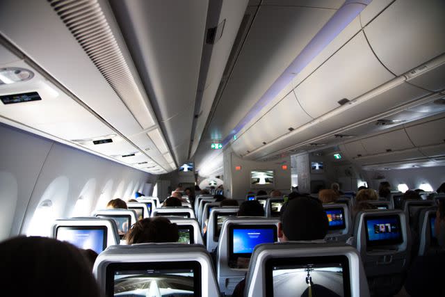 Artur Debat / Getty Images People seated on an airplane.