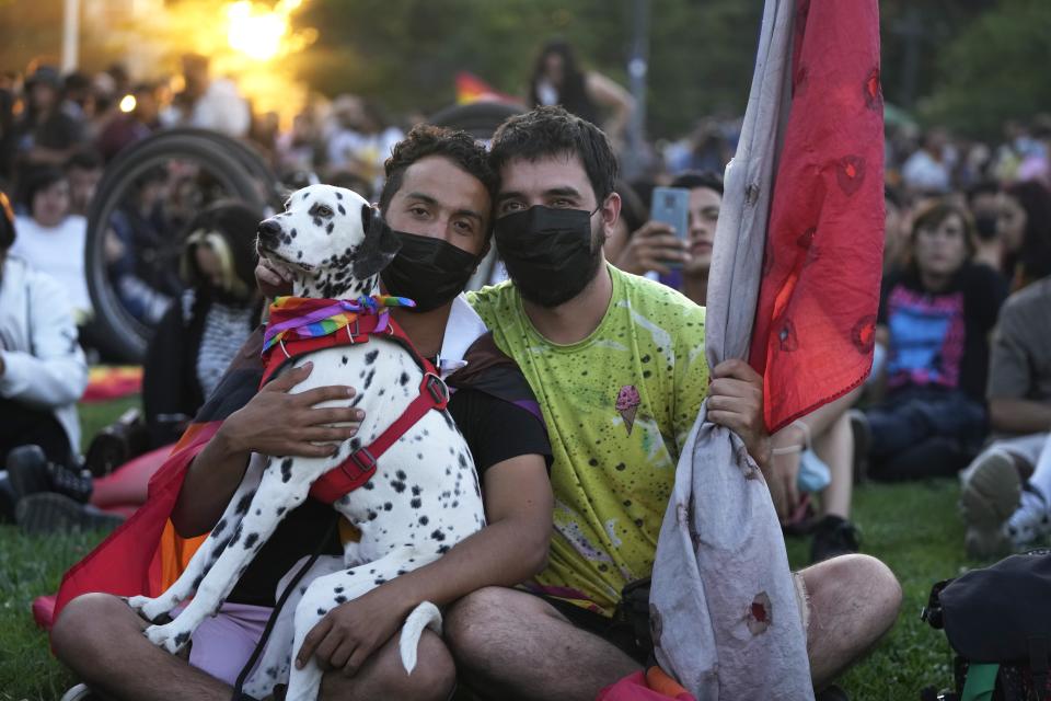 Members of the Movement for Homosexual Integration and Liberation celebrate after lawmakers approved legislation legalizing marriage and adoption by same-sex couples, in Santiago, Chile, Tuesday, Dec. 7, 2021. (AP Photo/Esteban Felix)