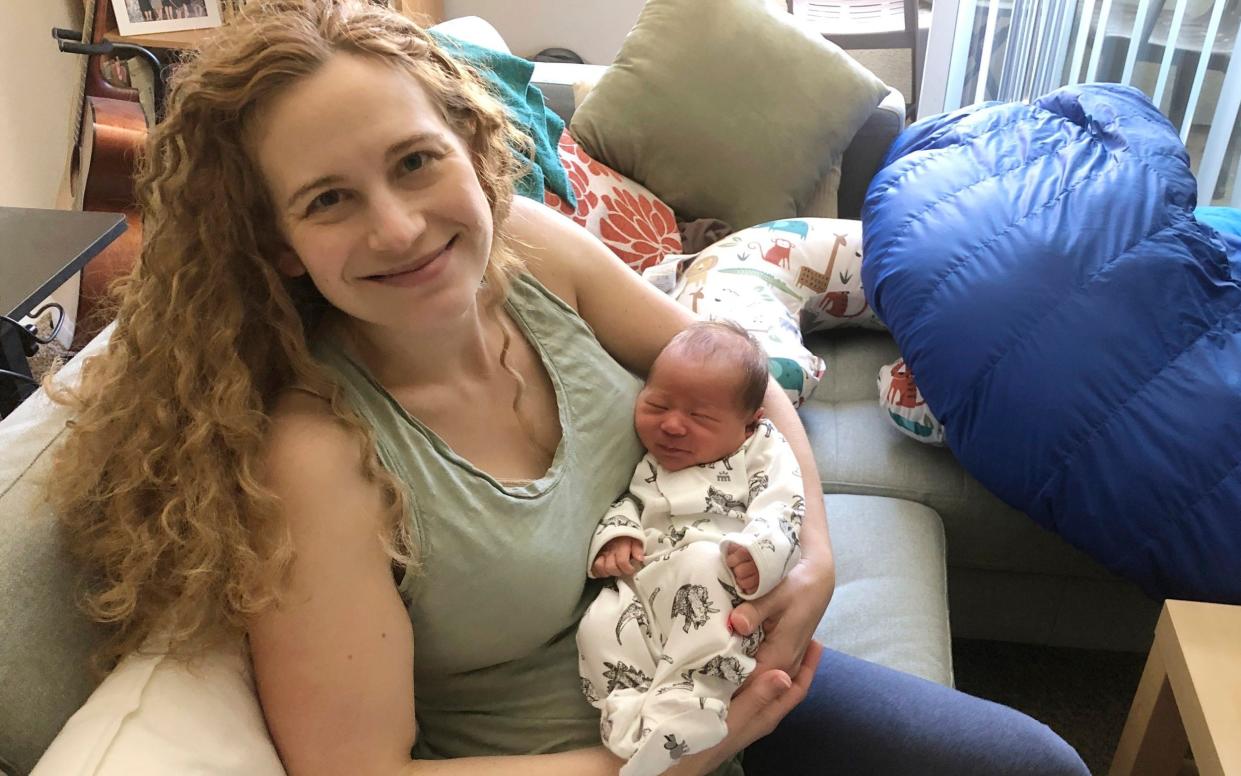 Liz Chrastil, a neuroscientist with the University of California, Irvine,  asshe her holds her newborn son in May 2020