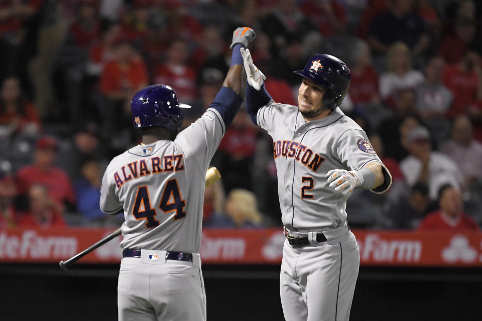 Houston Astros' Alex Bregman, right, is congratulated by Yordan Alvarez after hitting a solo home run during the second inning of a baseball game against the Los Angeles Angels, Friday, Sept. 27, 2019, in Anaheim, Calif. (AP Photo/Mark J. Terrill)