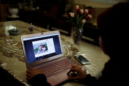 Palestinian woman Fatma Abu Musabbeh views one of her Instagram posts on her laptop in her family house in the central Gaza Strip November 8, 2018. Picture taken November 8, 2018. REUTERS/Mohammed Salem