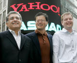 Yahoo! co-founders Jerry Yang (C) and David Filo (R) pose with chief executive Terry Semel.