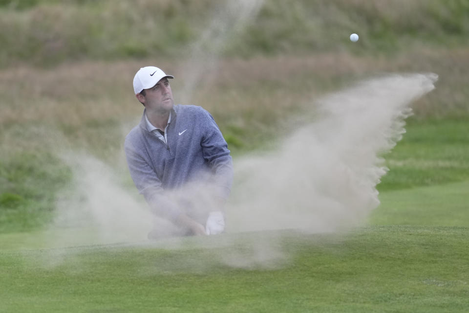 United States' Scottie Scheffler plays a shot from a bunker on the 18th green at went into the hole for a birdie during the second day of the British Open Golf Championships at the Royal Liverpool Golf Club in Hoylake, England, Friday, July 21, 2023. (AP Photo/Kin Cheung)
